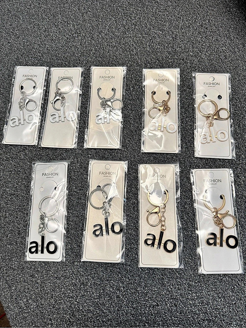 Alo Logo Keychain Set Gold & Silver NWT $15 each or all for $75